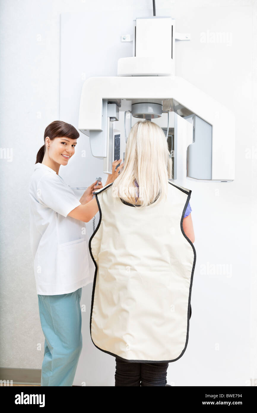 Young female orthodontist taking a panoramic digital xray of a patient`s teeth Stock Photo
